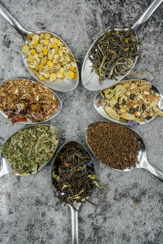 A selection of dried roots and botanical herbs arranged thoughtfully on a natural wooden surface