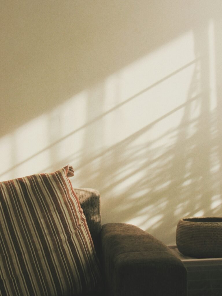 Soft sunlight hitting a clean minimalist listening room cushion set for peaceful rest