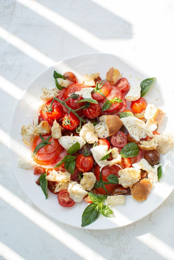 Fresh Mediterranean style meal with olive oil fish and greens served outdoors