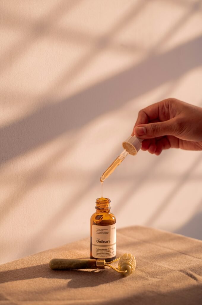 Minimalist glass dropper bottle with natural scalp serum resting on a stone shelf