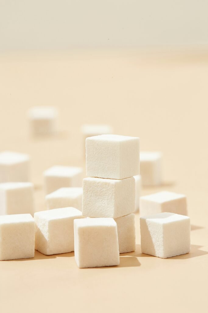 Asymmetric data list comparing glycemic impact, digestive tolerance, and taste profile across traditional sugar, erythritol, allulose, and tagatose